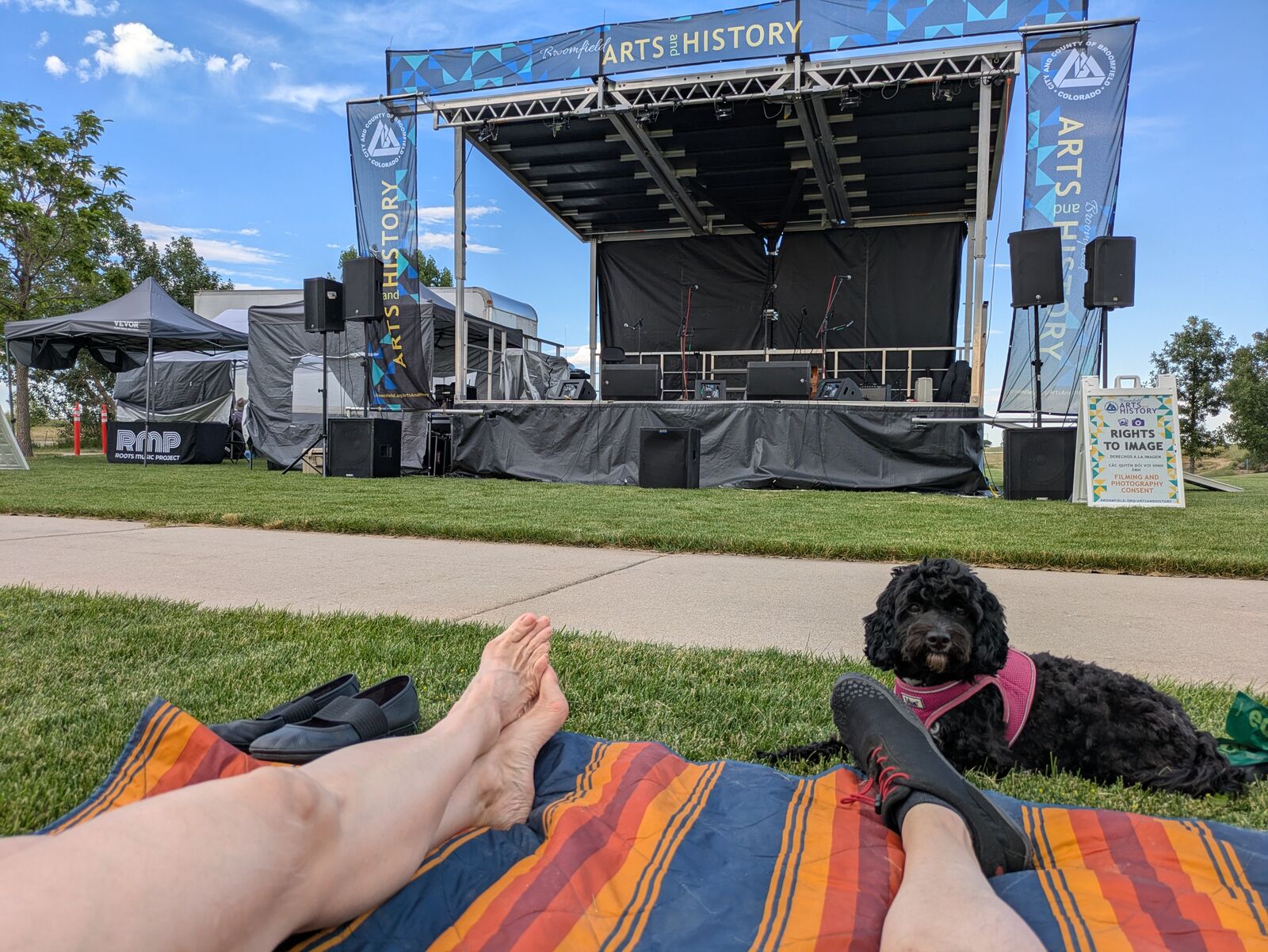 Outdoor concert stage seen from a picnic blanket