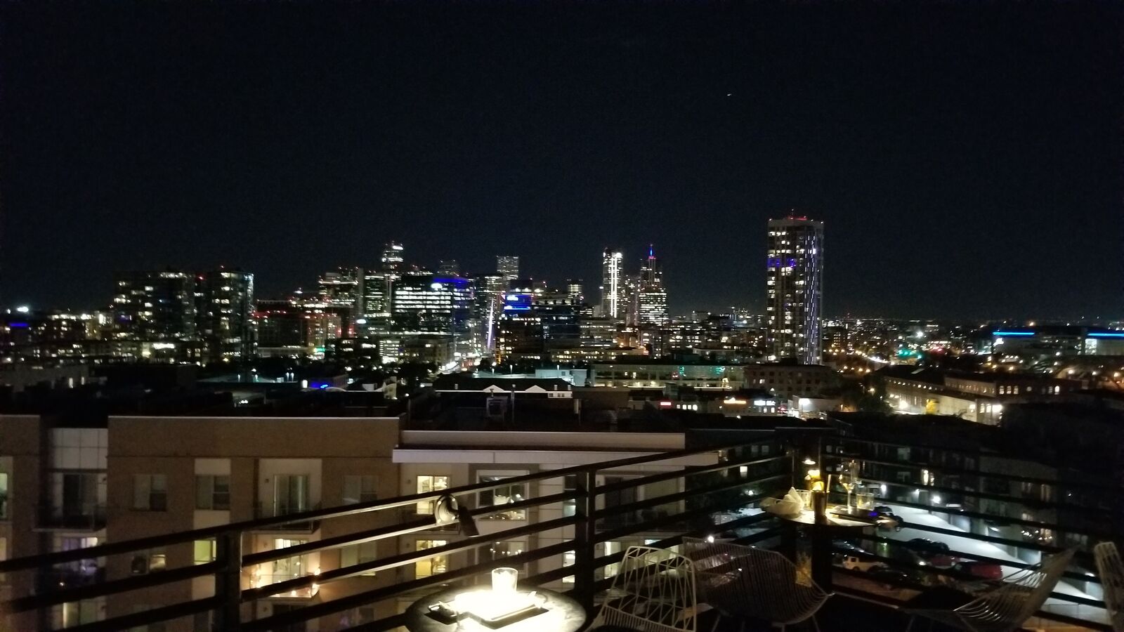 City skyline at night seen from a balcony